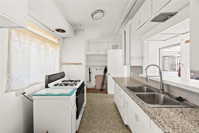 2517 S 2nd Ave, Arcadia, CA 91006 - kitchen with range with gas cooktop, a sink, white cabinetry, light countertops, and light floors