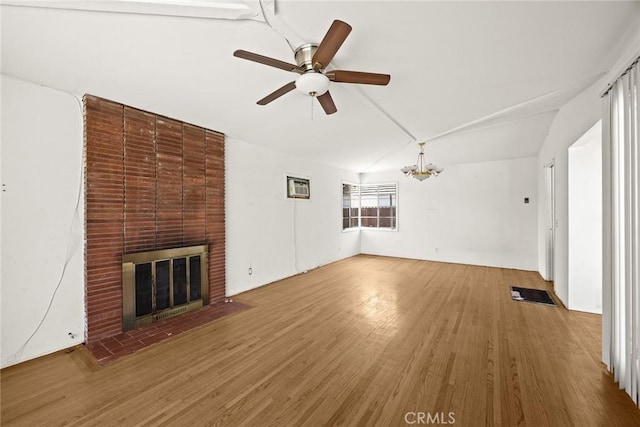 2517 S 2nd Ave, Arcadia, CA 91006 - unfurnished living room with vaulted ceiling, a brick fireplace, wood finished floors, a ceiling fan, and a chandelier