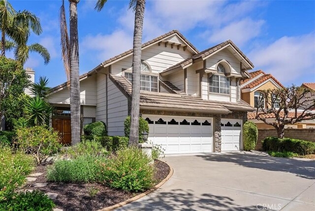 29206 Alfieri St, Laguna Niguel, CA 92677 - traditional-style house with an attached garage, a tile roof, and driveway