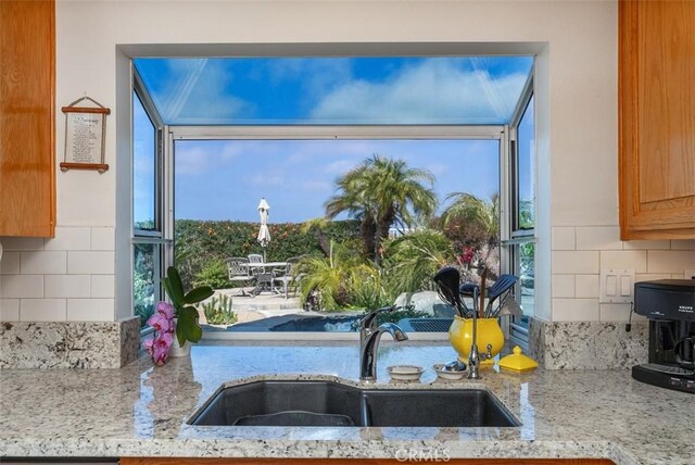 29206 Alfieri St, Laguna Niguel, CA 92677 - kitchen with a sink, decorative backsplash, and light stone countertops