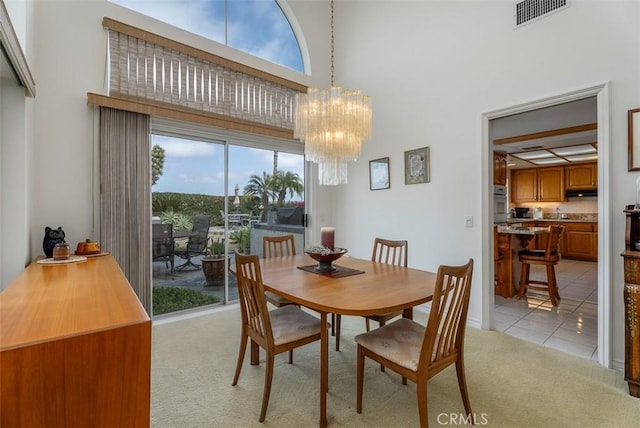29206 Alfieri St, Laguna Niguel, CA 92677 - dining room with light carpet, a towering ceiling, a chandelier, and light tile patterned flooring