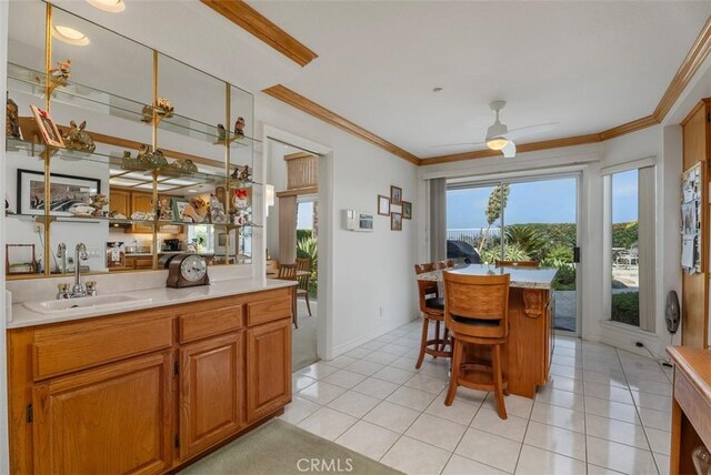 29206 Alfieri St, Laguna Niguel, CA 92677 - dining area with light tile patterned flooring, crown molding, and ceiling fan