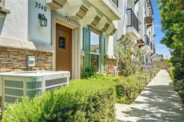 3540 W Savanna St, Anaheim, CA 92804 - view of exterior entry with central AC, stone siding, and stucco siding