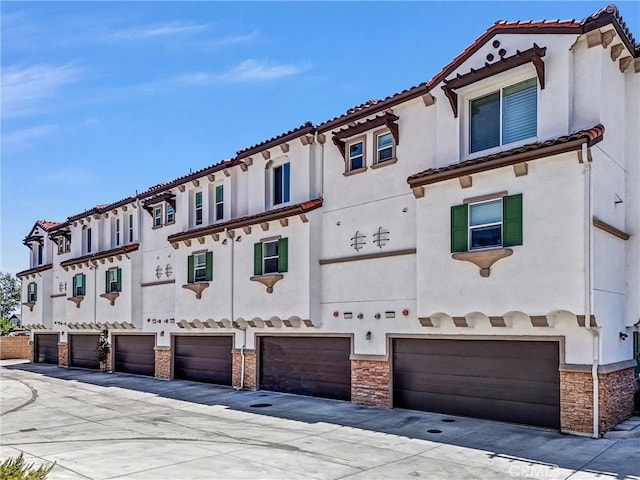 3540 W Savanna St, Anaheim, CA 92804 - view of front facade with stucco siding, a tiled roof, a garage, and stone siding