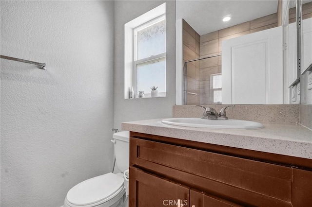 3540 W Savanna St, Anaheim, CA 92804 - bathroom featuring toilet, vanity, a textured wall, and a shower
