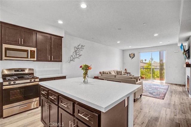 3540 W Savanna St, Anaheim, CA 92804 - kitchen featuring stainless steel appliances, light countertops, light wood-style floors, dark brown cabinets, and recessed lighting