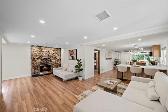 5742 Thelma Ave, La Palma, CA 90623 - living room with baseboards, recessed lighting, light wood-style flooring, and a fireplace