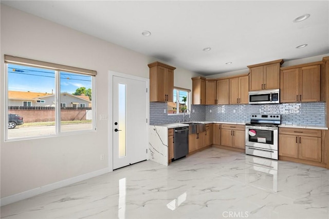 5742 Thelma Ave, La Palma, CA 90623 - kitchen with stainless steel appliances, baseboards, backsplash, light marble finish floors, and light countertops