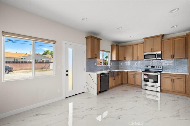 5742 Thelma Ave, La Palma, CA 90623 - kitchen featuring appliances with stainless steel finishes, baseboards, decorative backsplash, light marble finish floors, and light countertops