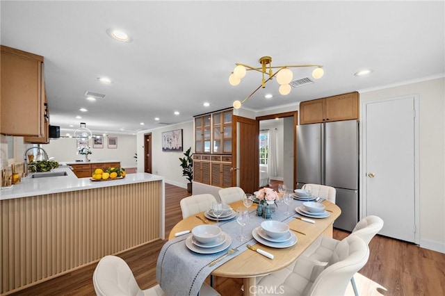 5742 Thelma Ave, La Palma, CA 90623 - dining space featuring wood finished floors, recessed lighting, crown molding, and baseboards