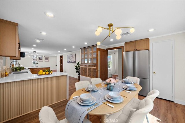 5742 Thelma Ave, La Palma, CA 90623 - dining area with wood finished floors, recessed lighting, crown molding, and baseboards