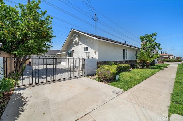 5742 Thelma Ave, La Palma, CA 90623 - view of property exterior with stucco siding, a gate, and stone siding