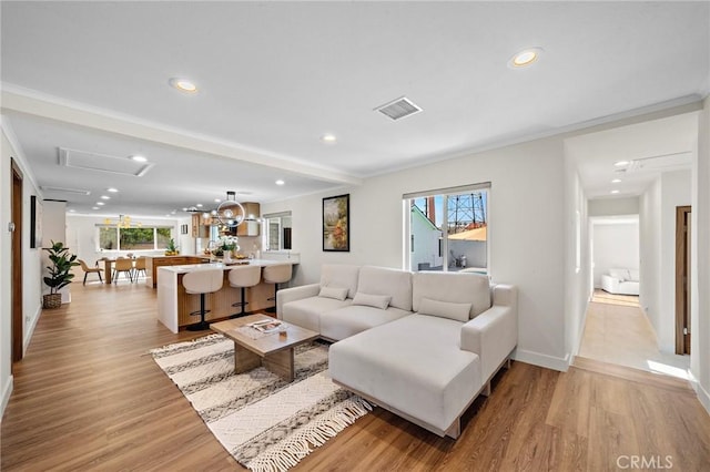 5742 Thelma Ave, La Palma, CA 90623 - living area with light wood finished floors, recessed lighting, baseboards, crown molding, and attic access