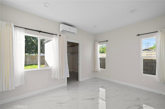 5742 Thelma Ave, La Palma, CA 90623 - unfurnished bedroom featuring an AC wall unit, baseboards, marble finish floors, and a spacious closet