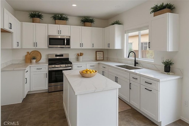 3929 Albillo, Perris, CA 92571 - kitchen featuring appliances with stainless steel finishes, a sink, a kitchen island, white cabinets, and recessed lighting