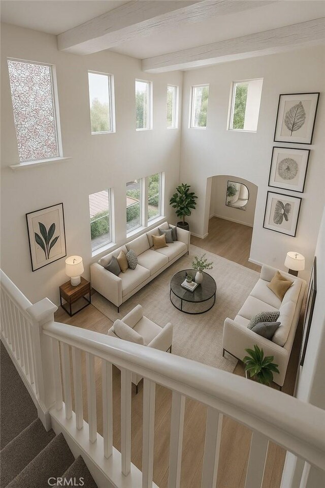 3929 Albillo, Perris, CA 92571 - living area with beamed ceiling, wood finished floors, and stairway