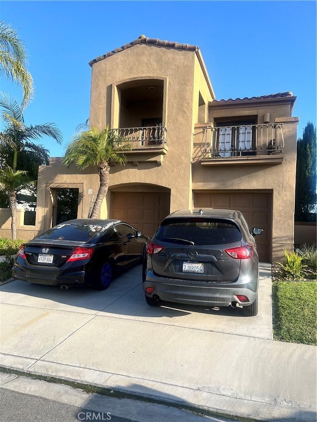 30 Galeana, Lake Forest, CA 92610 - view of front of property featuring an attached garage, a balcony, stucco siding, concrete driveway, and a tiled roof