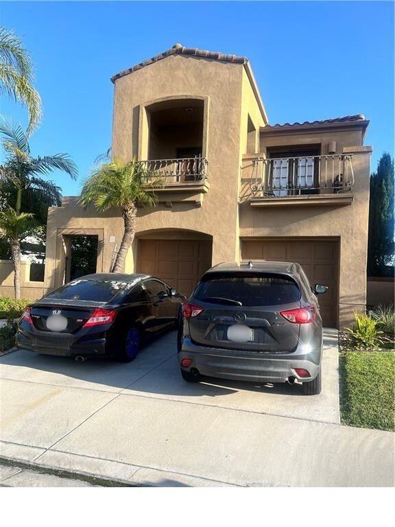 30 Galeana, Lake Forest, CA 92610 - mediterranean / spanish house with a garage, a balcony, driveway, stucco siding, and a tiled roof