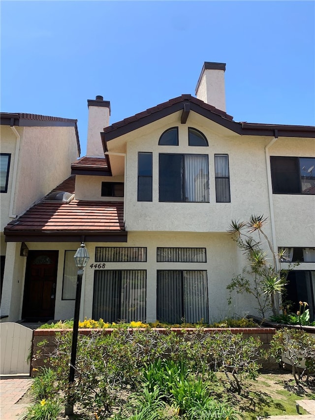 4468 Spencer St, Torrance, CA 90503 - view of property featuring a chimney and stucco siding
