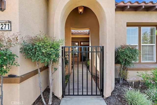 24271 Whitetail Dr, Corona, CA 92883 - property entrance featuring stucco siding, a gate, and a tiled roof