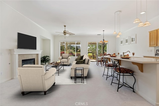 24271 Whitetail Dr, Corona, CA 92883 - living area featuring a tiled fireplace, light carpet, a chandelier, ceiling fan, and baseboards