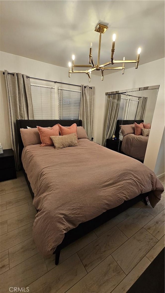 402 Hartzell Ave, Redlands, CA 92374 - bedroom featuring a chandelier and wood-type flooring