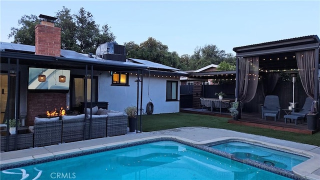 402 Hartzell Ave, Redlands, CA 92374 - view of swimming pool featuring outdoor lounge area, central AC unit, a pool with connected hot tub, a patio area, and a lawn