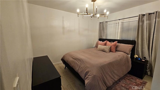 402 Hartzell Ave, Redlands, CA 92374 - bedroom featuring a chandelier, wood finished floors, and baseboards