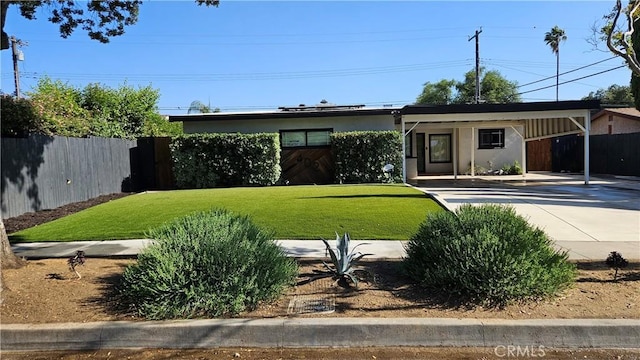 402 Hartzell Ave, Redlands, CA 92374 - ranch-style house featuring driveway, stucco siding, and an attached carport