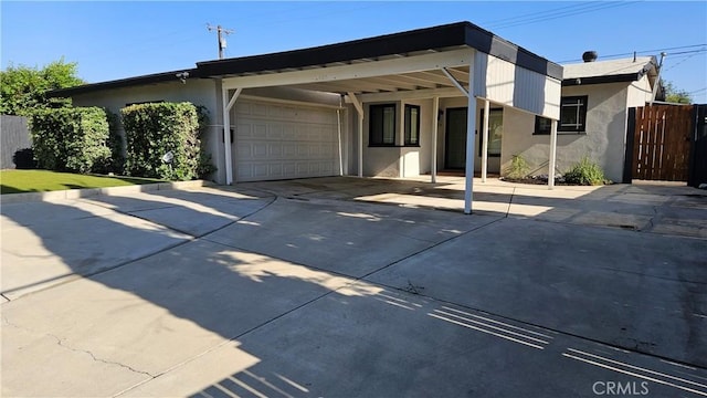 402 Hartzell Ave, Redlands, CA 92374 - view of front of property with concrete driveway, stucco siding, a carport, and a garage