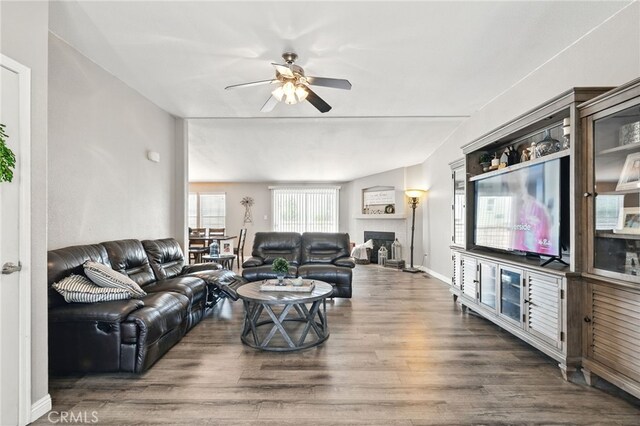 3595 Buchanan St, Riverside, CA 92503 - living room featuring ceiling fan, wood finished floors, a fireplace, and baseboards