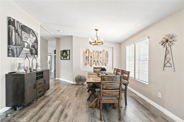 3595 Buchanan St, Riverside, CA 92503 - dining space with wood finished floors, baseboards, and a chandelier