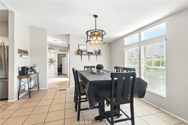 3595 Buchanan St, Riverside, CA 92503 - dining room featuring light tile patterned floors, a chandelier, baseboards, and vaulted ceiling