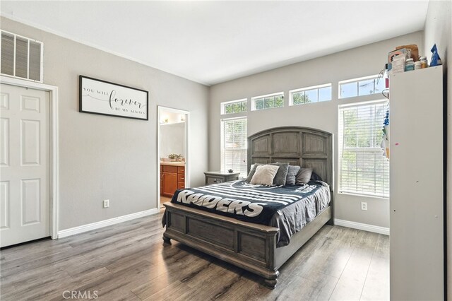 3595 Buchanan St, Riverside, CA 92503 - bedroom with wood finished floors, baseboards, and ensuite bathroom