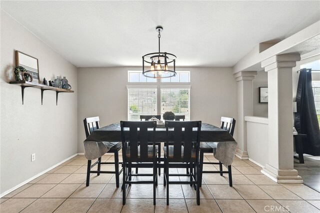 3595 Buchanan St, Riverside, CA 92503 - dining area featuring light tile patterned floors, decorative columns, and a chandelier