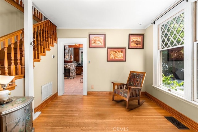 337 S Center St, Redlands, CA 92373 - sitting room with crown molding, stairs, light wood-style flooring, and baseboards