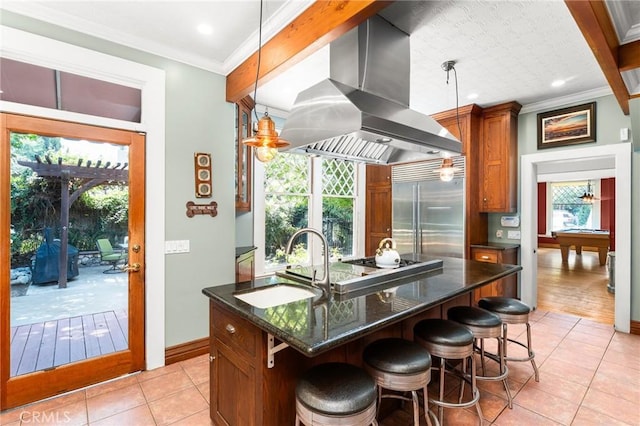 337 S Center St, Redlands, CA 92373 - kitchen with stainless steel built in fridge, range hood, a sink, light tile patterned flooring, and crown molding