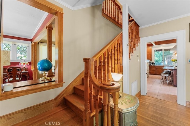 337 S Center St, Redlands, CA 92373 - stairs featuring wood finished floors, crown molding, and baseboards