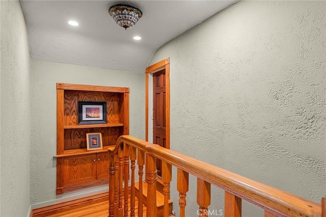 337 S Center St, Redlands, CA 92373 - hall with a textured wall, recessed lighting, vaulted ceiling, light wood-type flooring, and baseboards