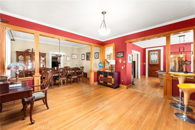 337 S Center St, Redlands, CA 92373 - dining space featuring light wood-type flooring, a chandelier, ornamental molding, baseboards, and ornate columns