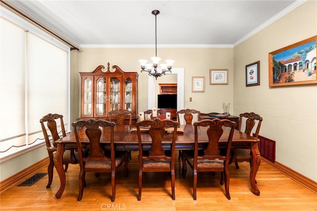 337 S Center St, Redlands, CA 92373 - dining space with a chandelier, light wood finished floors, crown molding, and baseboards