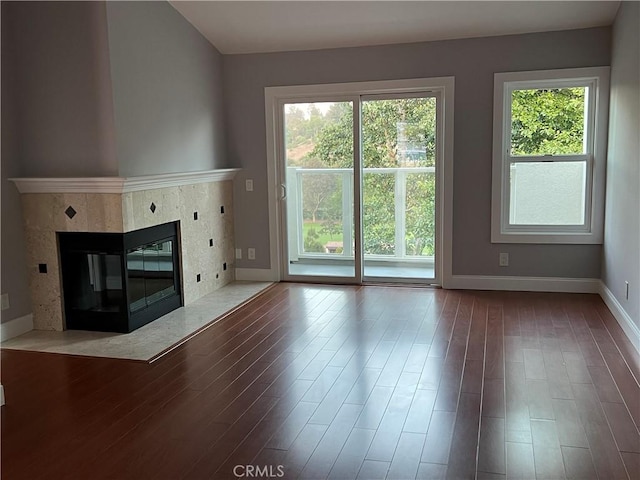 30902 Clubhouse Dr Unit 27H, Laguna Niguel, CA 92677 - unfurnished living room featuring baseboards, wood finished floors, and a premium fireplace