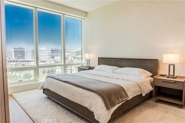 877 Francisco St Unit 1512, Los Angeles, CA 90017 - bedroom featuring a view of city and light wood-style flooring