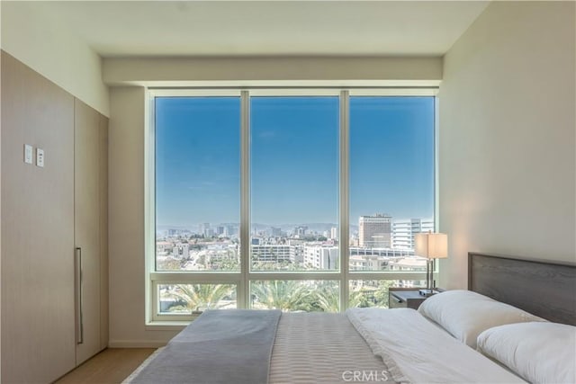 877 Francisco St Unit 1512, Los Angeles, CA 90017 - bedroom featuring a view of city and wood finished floors