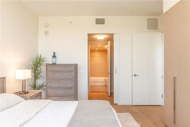 877 Francisco St Unit 1512, Los Angeles, CA 90017 - bedroom featuring light wood-type flooring and ensuite bathroom