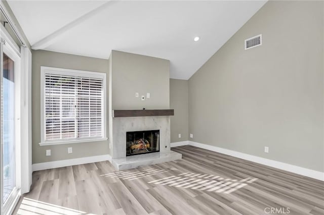 8039 E Snapdragon Ln, Anaheim, CA 92808 - unfurnished living room featuring wood finished floors, vaulted ceiling, a high end fireplace, baseboards, and recessed lighting
