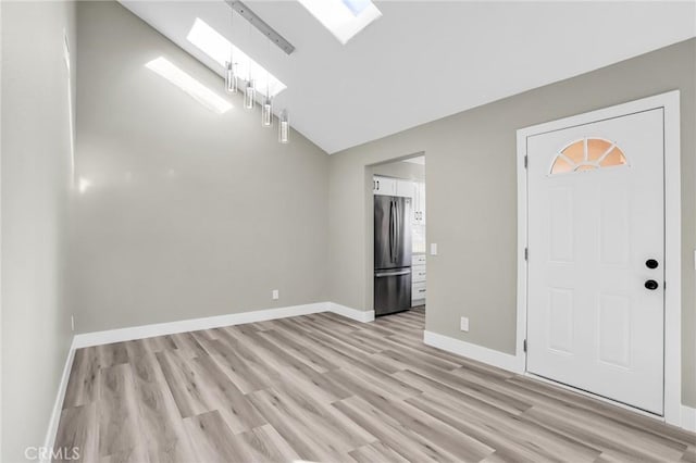 8039 E Snapdragon Ln, Anaheim, CA 92808 - entryway with a skylight, light wood-style flooring, lofted ceiling, and baseboards