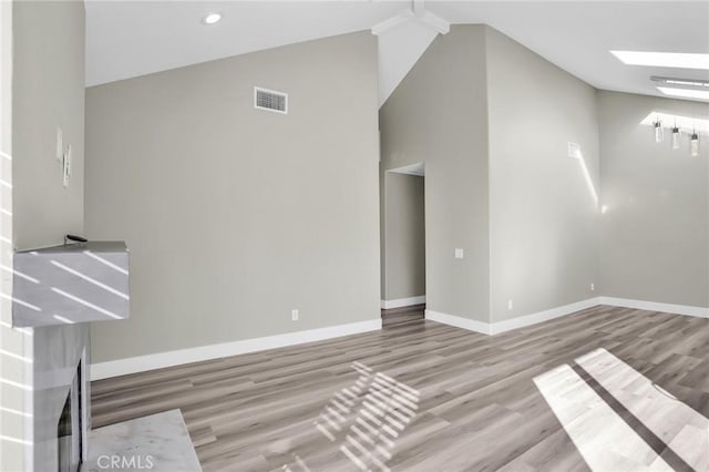 8039 E Snapdragon Ln, Anaheim, CA 92808 - unfurnished living room with high vaulted ceiling, wood finished floors, baseboards, and recessed lighting