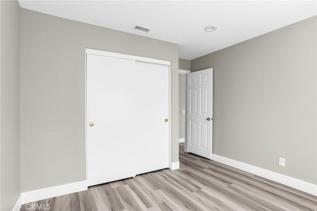 8039 E Snapdragon Ln, Anaheim, CA 92808 - unfurnished bedroom with wood finished floors, a closet, and baseboards