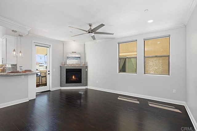 1135 Felspar St, Pacific Beach San Diego, CA 92109 - unfurnished living room featuring crown molding, dark wood-style flooring, ceiling fan, a fireplace, and baseboards